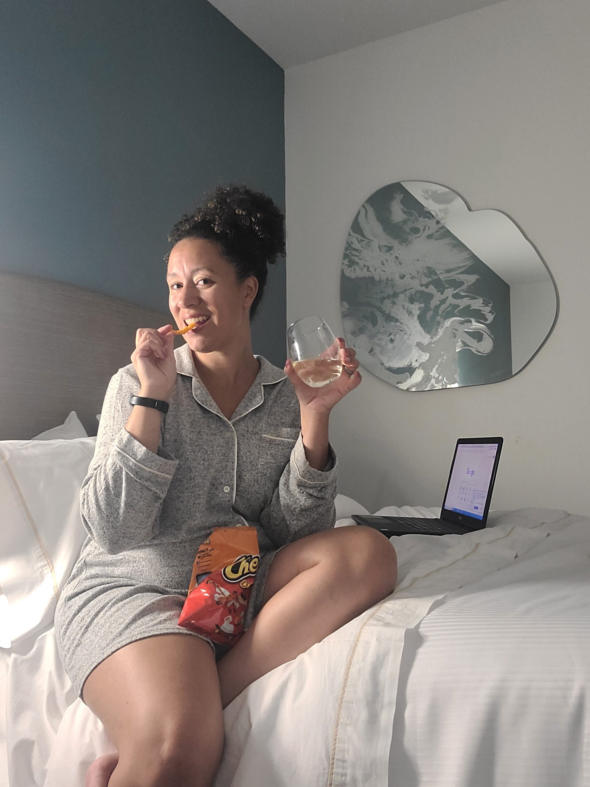 women on bed with food and wine